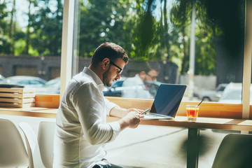 Attractive man working in cafe 