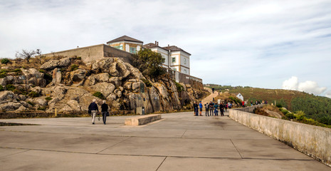 Finisterre, Spain-Octuber 2018. Pilgrims at the end of the Camino de Santiago on a cloudy day