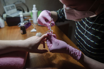 Cutting the cuticle on the nail with nail scissors