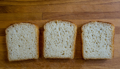 Three slices of the bread on the choping board