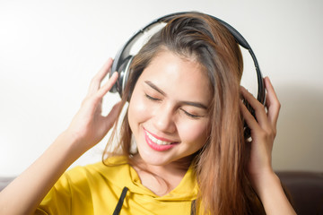 Fototapeta premium Beautiful woman is listening music in home