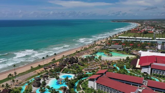 Aerial view of tourist resort town Porto de Galinhas, white sand beach and turquoise bright-water of Atlantic Ocean - landscape panorama of Brazil from above, South America