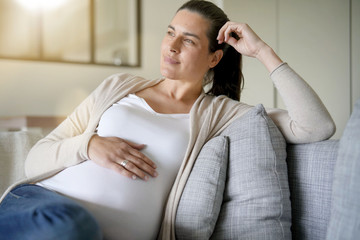 Portrait of pregnant woman relaxing in sofa