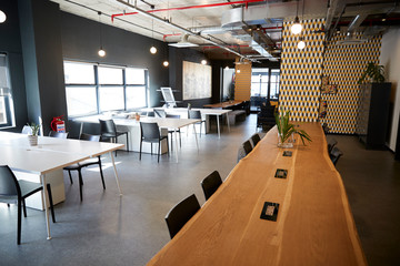 Wooden counter bar in the dining area of a creative business in daylight, no people