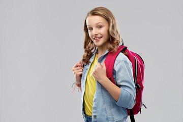 education, school and people concept - happy smiling teenage student girl with bag over grey background