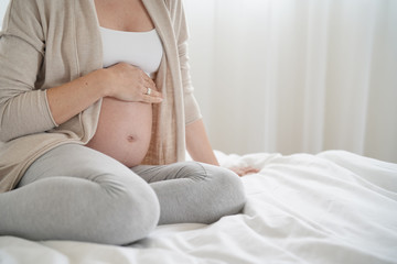 Obraz na płótnie Canvas Closeup of pregnant woman belly