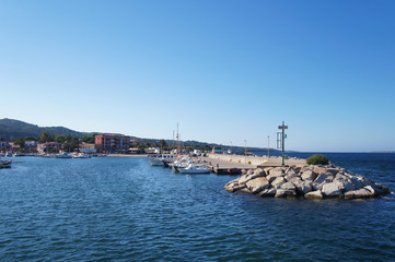 Fototapeta na wymiar Yacht club with snow-white ships on the pier in the lagoon in the port.