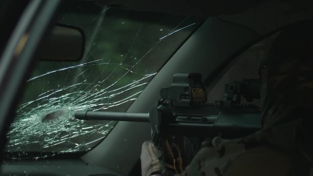 Shooting from a car, a rifle with a silencer. Rifle shooting. Fully equipped sniper. Secret mission, Operation in Action. Slow Motion. 4K. UHD.