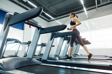 Obraz premium Fit girl with red short hair in gym