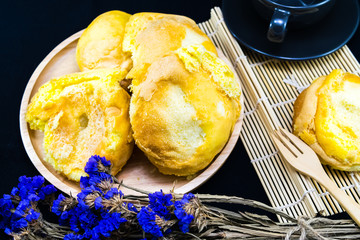 Easter cupcakes in wooden bowl on dark black background
