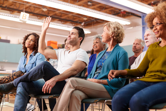 Man Asking Question At Neighborhood Meeting In Community Center