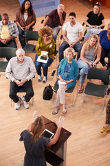 Overhead View Of Group Attending Neighborhood Meeting In Community Center