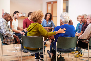 People Attending Self Help Therapy Group Meeting In Community Center - obrazy, fototapety, plakaty