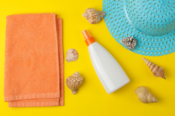 Sunscreen. various sunscreens on a bright yellow background and summer accessories. summer. vacation. top view