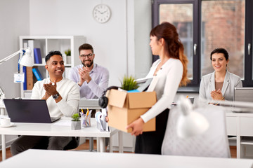 business, new job and quit concept - happy smiling colleagues applauding to female office worker...
