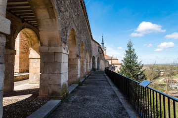 Fototapeta na wymiar Arcade in the medieval wall of the town of Lerma