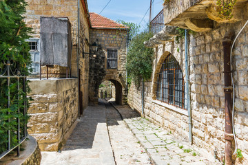 This is a capture of the old roads in Der El Kamar a village Located in Lebanon and you can see in the picture the old walk made of stones with an historic architecture for walls and houses 