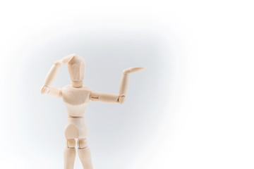 Wooden dummy proudly presents some invisible thing, isolated on white background, copy space for your object or text