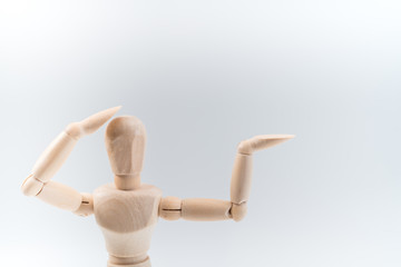 Wooden dummy proudly presents some invisible thing, isolated on white background, copy space for your object or text