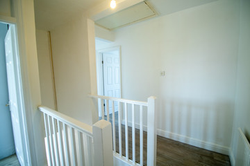 Fototapeta na wymiar White property interior upstairs hallway