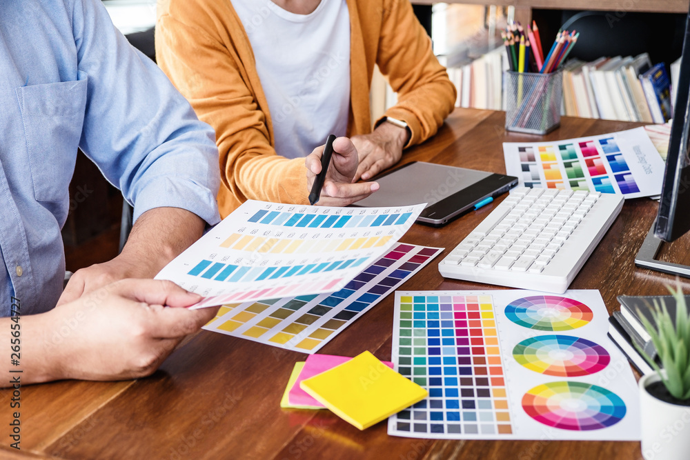 Aufkleber Two colleagues creative graphic designer working on color selection and drawing on graphics tablet at workplace