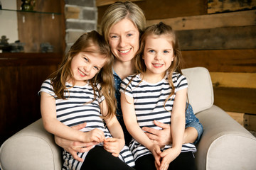 A Happy loving family Mother and twin daughters childs girl portrait