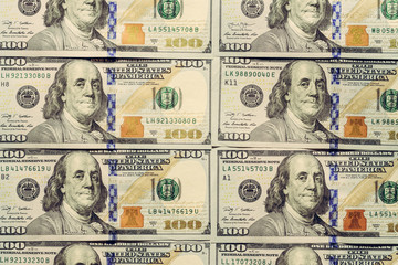 American dollars are put up in a row, a note worth a hundred dollars, a texture.
