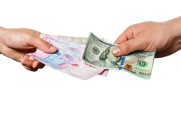 People exchange hryvnia for dollars, only hands can be seen on a black background.