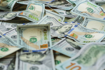 Dollar notes are lined up on a table close-up, a texture of dollar bill.