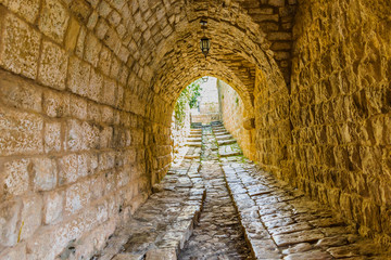 This is a capture of the old roads in Der El Kamar a village Located in Lebanon and you can see in the picture the old walk made of stones with an historic architecture for walls and houses 