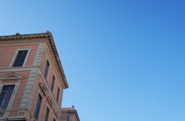 Fototapeta na wymiar Old house building against the blue sky. Architecture of an old medieval european italian city.
