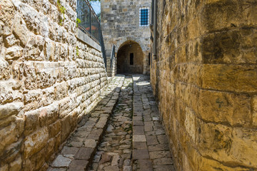 Fototapeta na wymiar This is a capture of the old roads in Der El Kamar a village Located in Lebanon and you can see in the picture the old walk made of stones with an historic architecture for walls and houses 
