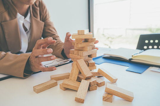 Problem Solving Business can't stop effect of dominoes continuous toppled with business team feeling sad and stress in office background. Failure Business Concept