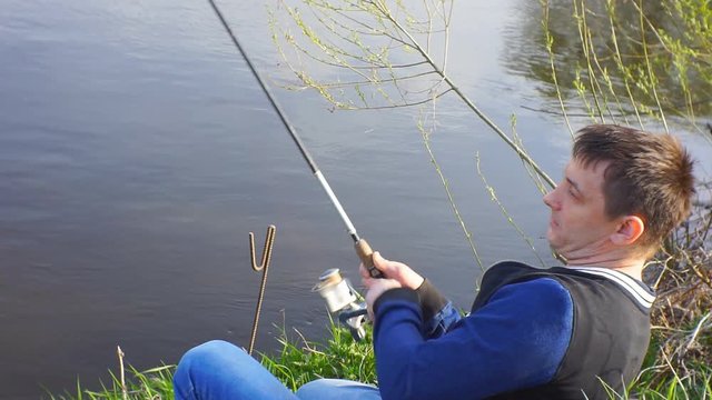 Fisherman pulls fish from shore.1920X1080 Full Hd.