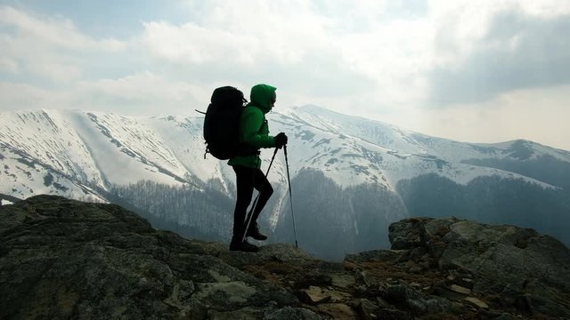 Hiker with backpack in snowy mountains. Ultra HD 4K video