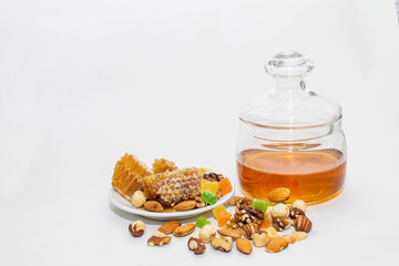 sweets on a white background, honey, candied fruits and nuts