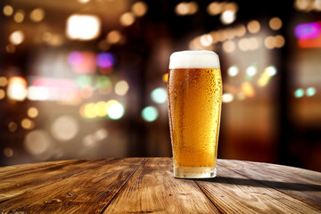 Fresh cold beer in glass and free space for your bottle. Bar interior background  - Powered by Adobe