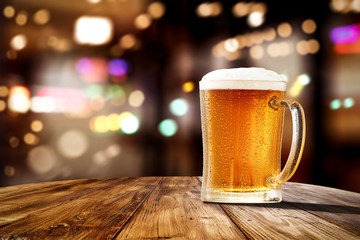 Fresh cold beer in glass and free space for your bottle. Bar interior background 