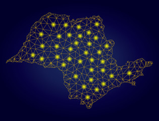Obraz premium Yellow mesh vector Sao Paulo State map with glitter effect on a dark blue gradiented background. Abstract lines, light spots and circle dots form Sao Paulo State map constellation.