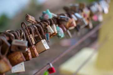 Lock for couple make a promise to love forever, master keys hanging on the rails of bridge, the sign of love and romantic affection as a landmark. Symbolic love locks hang along.