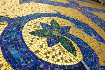 Fototapeta na wymiar Mosaic fragment. Floral ornament blue on a golden background.