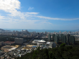 China, Hainan Province, view of the city of Sanya, in the foreground of the house, apple trees. Horizontal photo