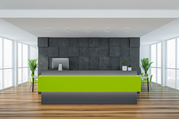 Green reception desk in gray office
