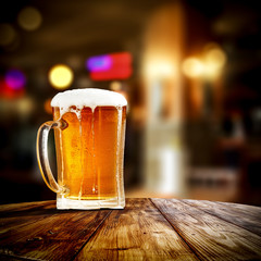 Fresh cold beer in glass and free space for your bottle. Bar interior background 