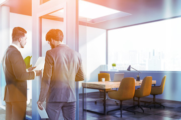 Fototapeta premium Two businessmen in office lobby interior