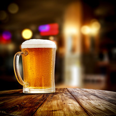 Fresh cold beer in glass and free space for your bottle. Bar interior background 