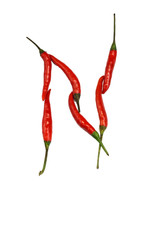 Alphabet of hot spice cayenne chili peppers isolated on white. Vegetable chili peppers in shape of...