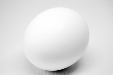 white egg on neutral background