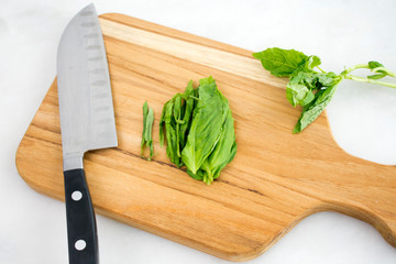 Julienned Basil Leaves on a Cutting Board