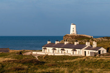 Fototapeta na wymiar Lighthouse and cottages on coast